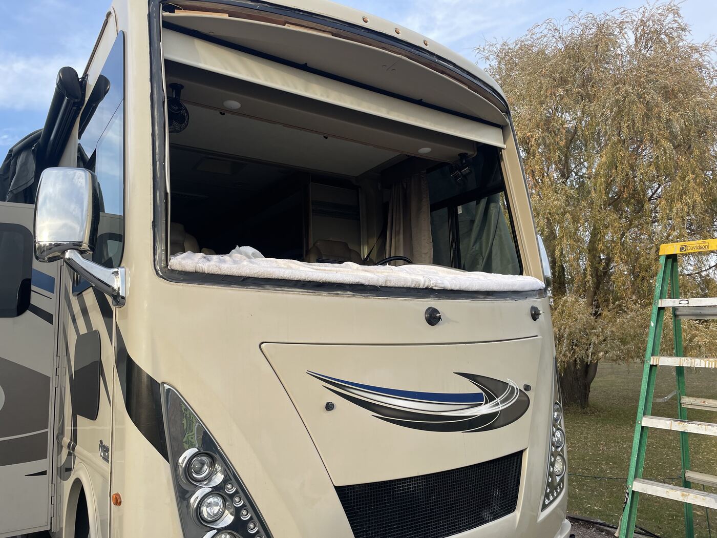 RV with its front windshield removed, before replacement